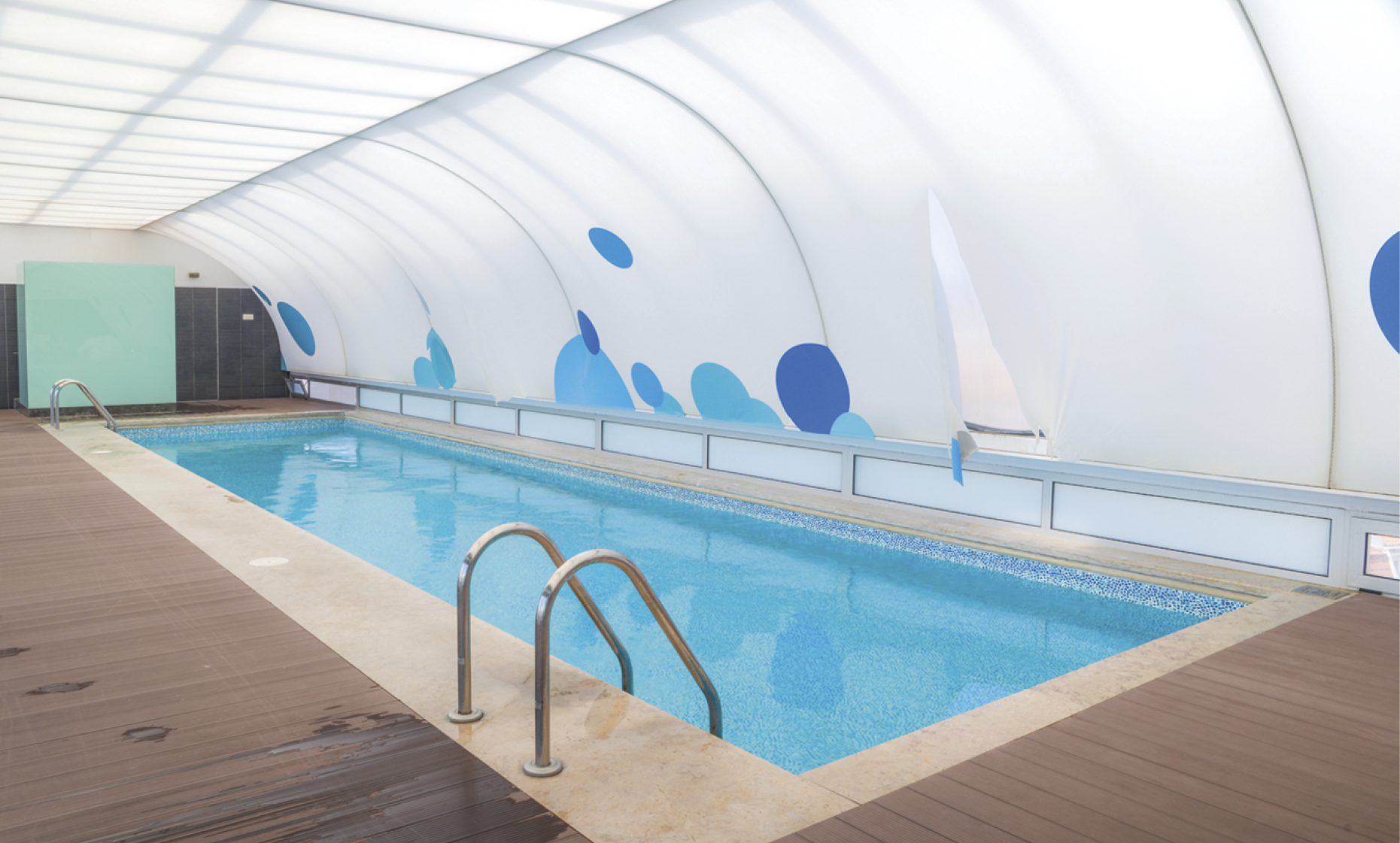 Wide angle view of swimming pool with a roof 