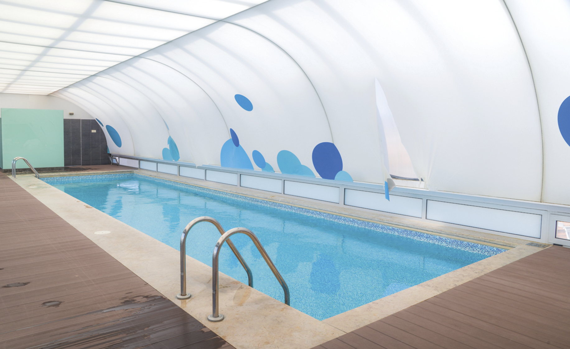 Wide angle view of swimming pool with a roof 