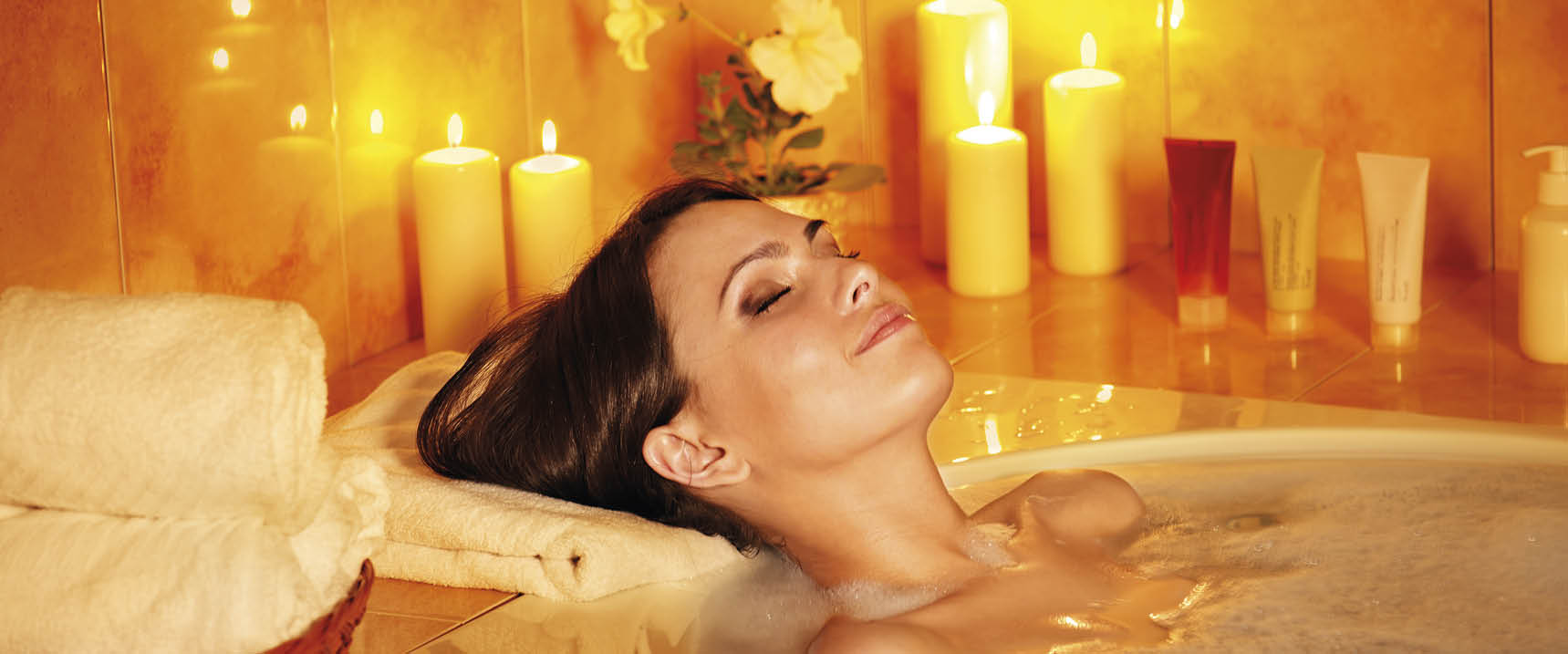 Young woman take bubble  bath with candle 