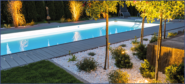 Scenic Residential Outdoor Swimming Pool Illuminated by LED Lighting. Poolside Surrounding Theme.