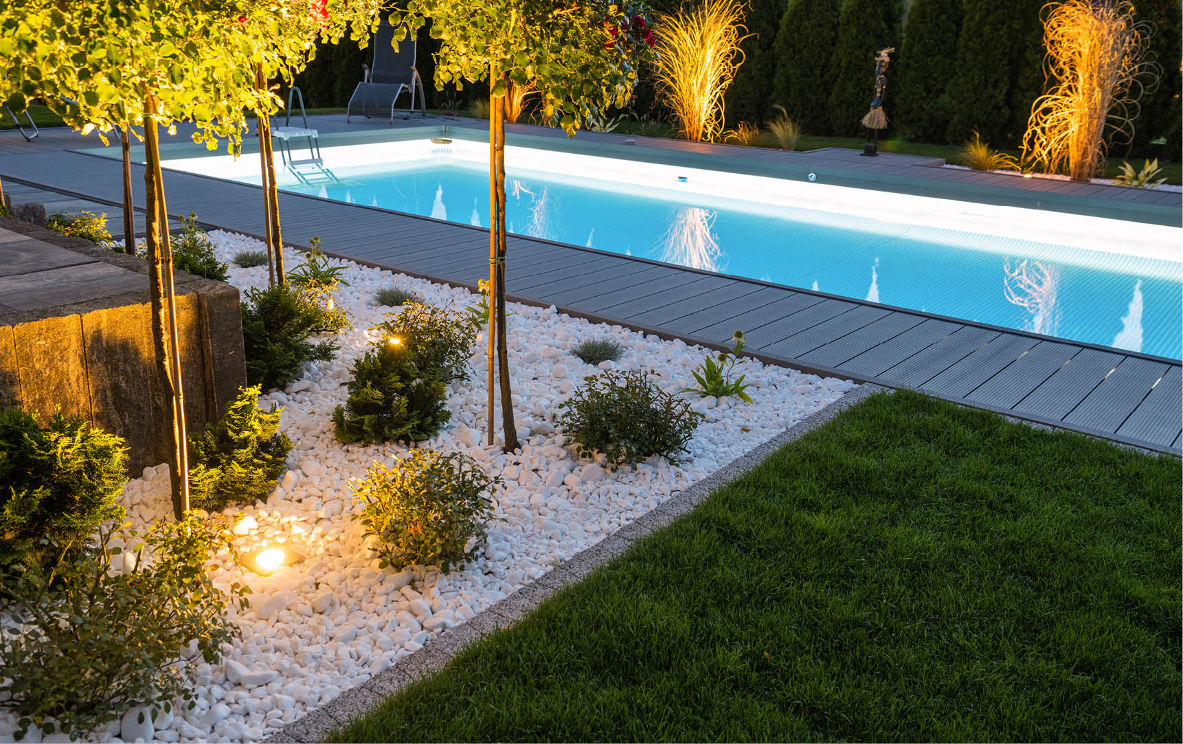 Scenic Residential Outdoor Swimming Pool Illuminated by LED Lighting. Poolside Surrounding Theme.