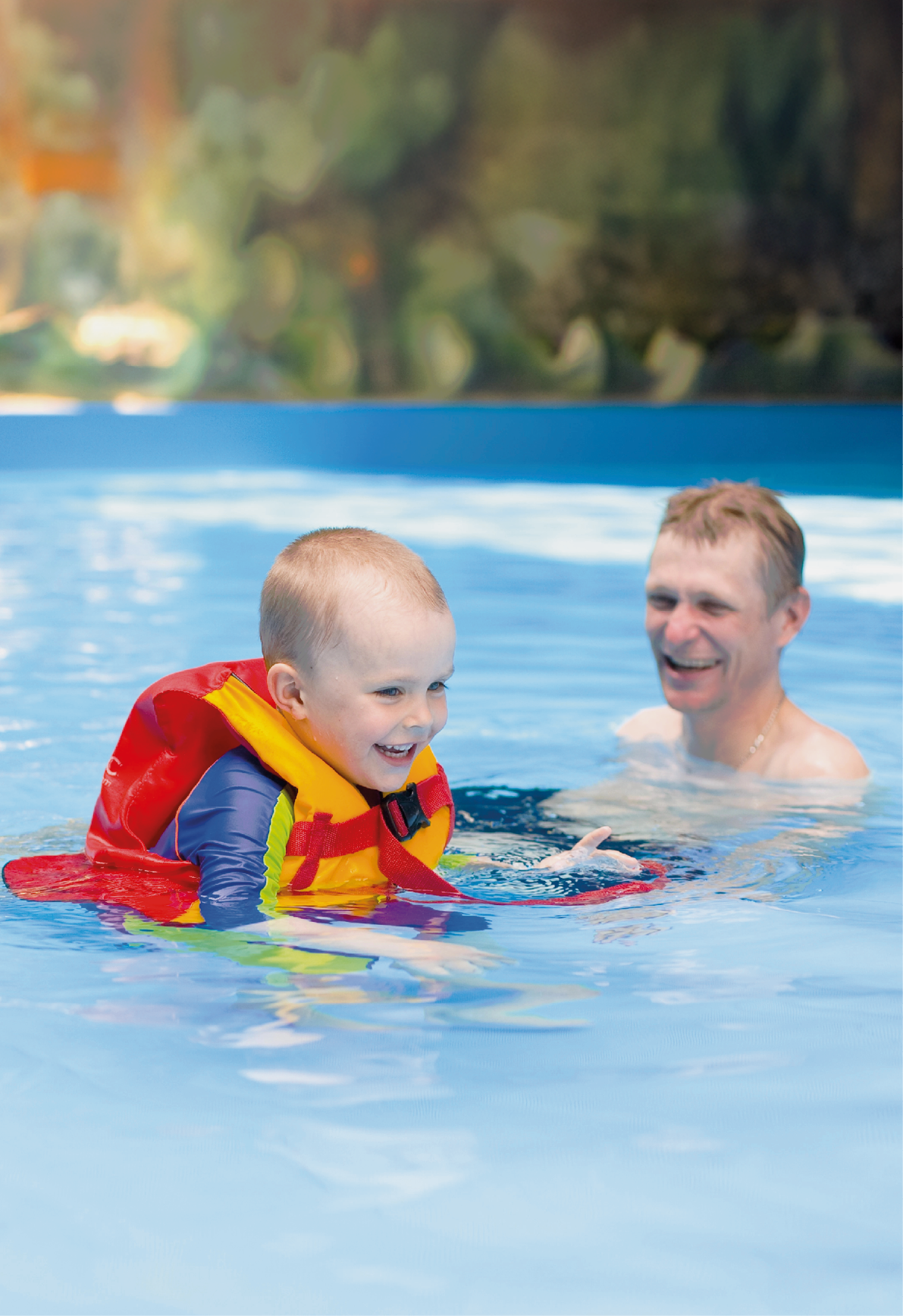 Boy of 4 years learns to swim in pool with father